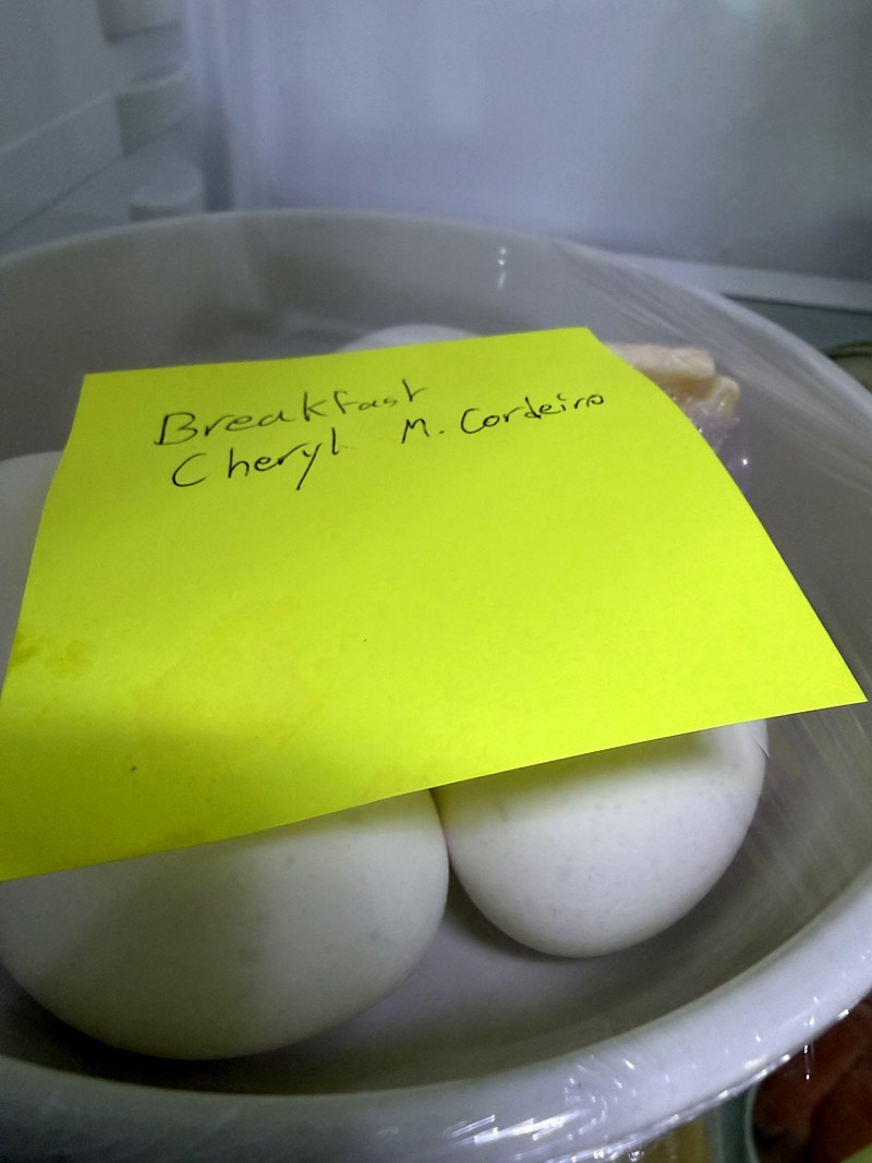 Yellow post-it reading Breakfast Cheryl M. Cordeiro on a bowl of boiled eggs